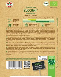 Bunte Packet mit grüner Zucchini, Text, Logos und Barcode auf braunem Hintergrund.