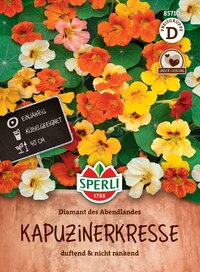 Bunte Kapuzinerkresse mit grünen Blättern, Blüten in Gelb, Orange, Rot und Weiß, auf Gartenboden.