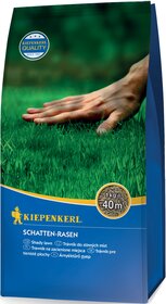 Hand schneidet Schattenrasen auf grüner Rasenfläche, Verpackung mit Blattschrift und Logo.